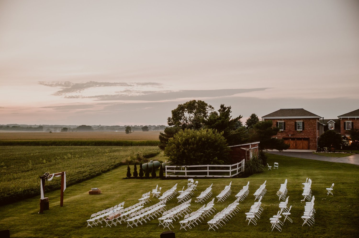 Bride and groom framed in the open barn doors during their ceremony